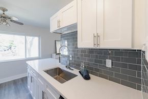 Crestwood apartment for rent - a kitchen with white cabinets and a sink