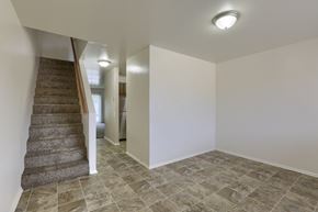Etters apartment for rent - an empty living room with a staircase in a house with white walls