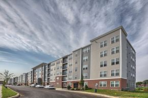 Lititz apartment for rent - a large apartment building on a street with a cloudy sky
