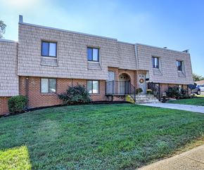 Shippensburg apartment for rent - A brick house with a green lawn in front.