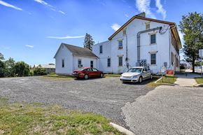 Arendtsville apartment for rent - an old white building with two cars parked in front of it