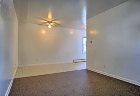 Arendtsville apartment for rent - a living room with white walls and a ceiling fan