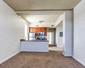 Harrisburg apartment for rent - an empty living room and kitchen with a counter top and a refrigerator
