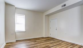 Harrisburg apartment for rent - a bedroom with white walls and wood flooring and a door