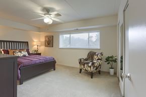 Harrisburg apartment for rent - a bedroom with a large bed and a ceiling fan