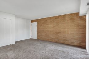 Elizabethtown apartment for rent - a bedroom with a brick wall and a carpeted floor