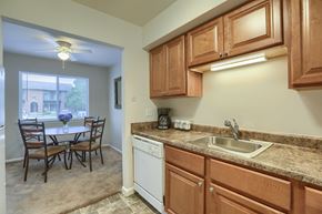 Mechanicsburg apartment for rent - Mechanicsburg Apartments | Delbrook Manor Apartments | a kitchen with wooden cabinets and a white dishwasher