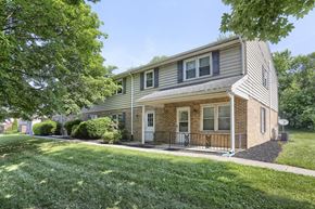 York apartment for rent - the front of a house with a lawn and trees