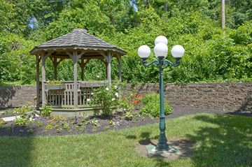 Camp Hill apartment for rent - a garden with a gazebo and a lamp post