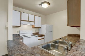 Williamsport apartment for rent - a kitchen with white appliances and granite counter tops