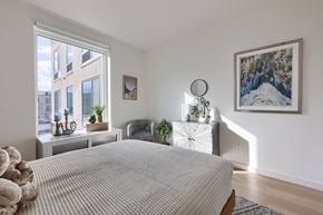 Lancaster apartment for rent - A bedroom with a large bed and a painting on the wall.