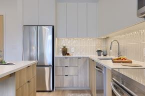 Lancaster apartment for rent - A modern kitchen with a stainless steel refrigerator and wooden cabinets.