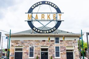 Harrisburg apartment for rent - the sign for broad street market on top of a brick building