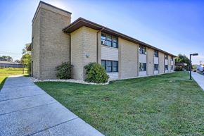 Mercersburg apartment for rent - a brick building with green grass and a sidewalk
