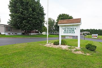 Ephrata apartment for rent - A sign for Victoria Manor Estates stands in a grassy area.