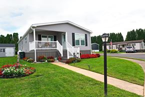 Ephrata apartment for rent - A house with a grey and white exterior and a small porch.