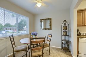 Mechanicsburg apartment for rent - Mechanicsburg Apartments | Delbrook Manor Apartments | a dining room with a large window and a ceiling fan