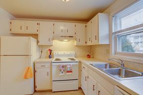 Akron apartment for rent - a kitchen with white appliances and white cabinets and a sink