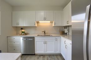 Hershey townhouse for rent - A kitchen with white cabinets and a stainless steel refrigerator.