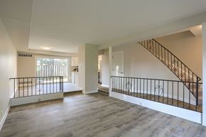Hershey townhouse for rent - A spacious room with a staircase and a balcony.