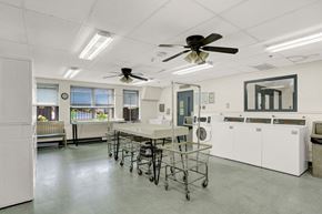 Lancaster apartment for rent - a laundry room with a table and chairs and two ceiling fans