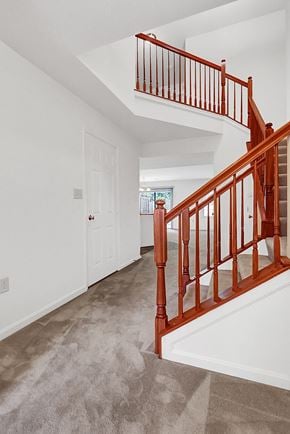 Harrisburg apartment for rent - the entryway of a home with a staircase and carpeted floors