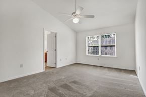 Harrisburg apartment for rent - an empty living room with a ceiling fan and a window
