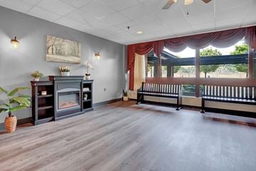 Sunbury apartment for rent - a living room with a fireplace and a window with curtains