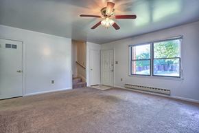 Chambersburg apartment for rent - an empty living room with a ceiling fan and a large window