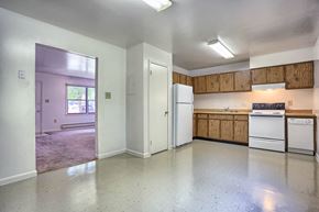 Chambersburg apartment for rent - an empty kitchen with white appliances and wooden cabinets