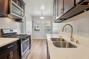Los Angeles apartment for rent - A kitchen with dark wood cabinets and a stainless steel sink.