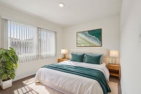 Los Angeles apartment for rent - A bedroom with a large bed and a painting on the wall.