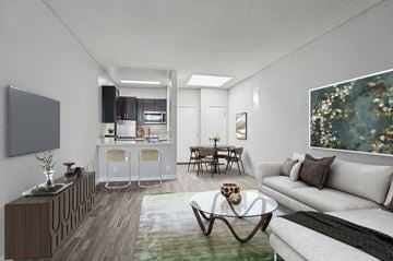 Panorama City apartment for rent - A modern living room with a grey sofa, a wooden coffee table, and a painting on the wall.