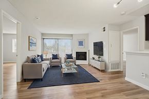 Van Nuys apartment for rent - A living room with a couch, chairs, and a coffee table.
