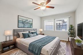 Los Angeles apartment for rent - A bedroom with a bed, a ceiling fan, and a window.