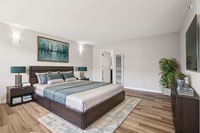 Lake Balboa apartment for rent - A bedroom with a large bed and a painting on the wall.
