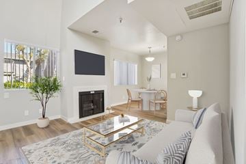Hawthorne apartment for rent - A living room with a fireplace and a television on the wall.