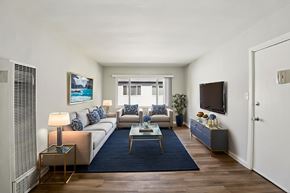 Los Angeles apartment for rent - A living room with a white sofa, a coffee table, and a television.