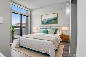Panorama City apartment for rent - A bedroom with a large bed and a painting on the wall.