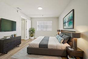 Hawthorne apartment for rent - A bedroom with a large bed and a television.