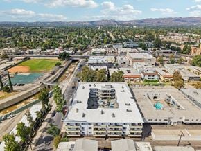Canoga Park apartment for rent - A large building with a pool in the middle of it.