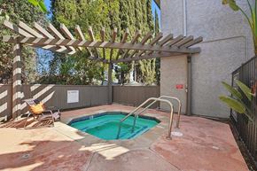 Van Nuys apartment for rent - A small pool with a wooden pergola over it.