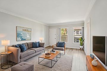 Los Angeles apartment for rent - A living room with a grey couch, a coffee table, and a painting on the wall.