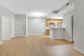 North Hollywood apartment for rent - A spacious room with wooden flooring and white walls.