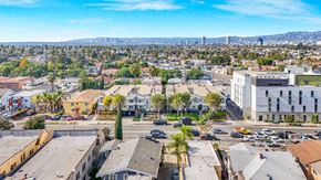 Los Angeles apartment for rent - A cityscape with buildings and cars on the streets.