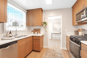 Inglewood apartment for rent - A kitchen with wooden cabinets and a black stove top oven.