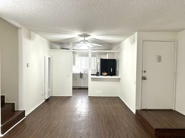 Los Angeles apartment for rent - A living room with a television and a staircase.