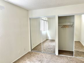 Westwood apartment for rent - an empty bedroom with mirrored closet doors and carpeted flooring