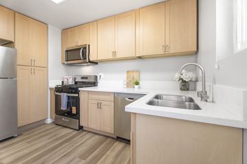 Los Angeles apartment for rent - A kitchen with wooden cabinets and a stainless steel refrigerator.