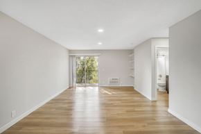 Van Nuys apartment for rent - A spacious room with wooden floors and white walls.